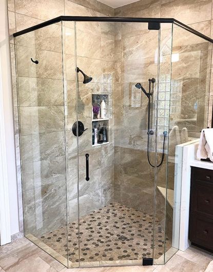 Neo-angle top-bar frameless shower door installed in a Broward County home